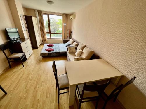a living room with a couch and a table at Julia Vigo Panorama apartments in Nesebar