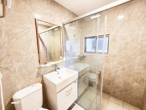 a bathroom with a toilet and a sink and a shower at Royal Business Hotel in Nantou City