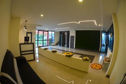 a living room with a large flat screen tv at Seasons Stay in Vijayawāda