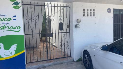 a white car parked in front of a gate at INDUSTRIAL.SMART HOME in Mérida