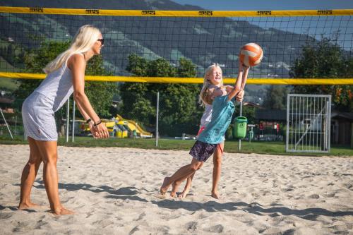 two girls playing a game of volley ball on the beach at monas home mayrhofen in Mayrhofen