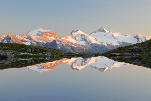 a mountain reflecting in a body of water at monas home mayrhofen in Mayrhofen