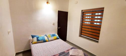 a small room with a couch and a window at Forestay -3 BHK Villa Kochi in Pallipuram