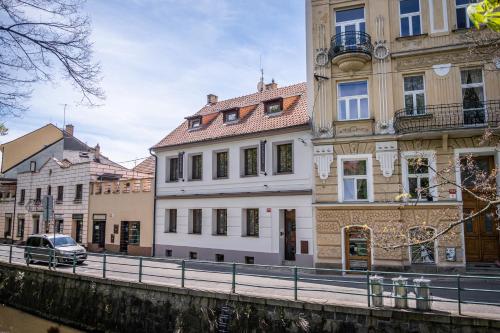 a row of buildings next to a river at Boutique Apartments Old Town in České Budějovice