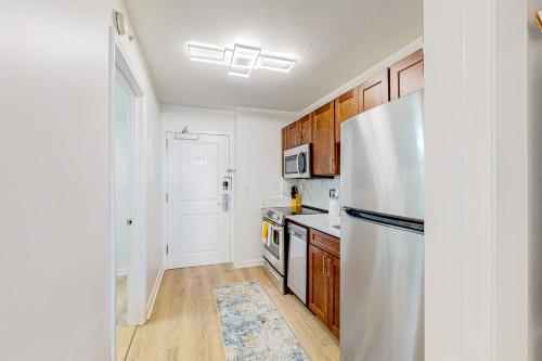 a kitchen with a white refrigerator and wooden cabinets at Club Wyndham 521 in Myrtle Beach