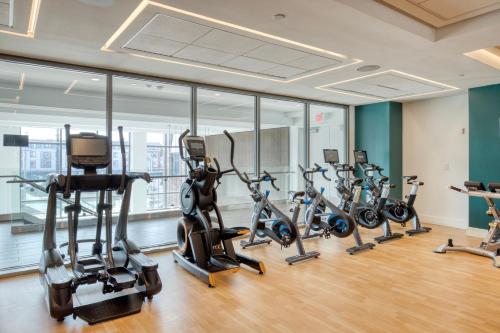 a row of exercise bikes in a gym at 1BR w Gym WD Steps from Newtonville Train BOS-353 in Newton