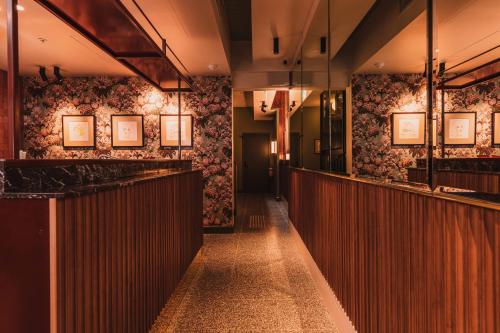 a corridor of a restaurant with a bar at The Sarah by Urban Rest in Sydney