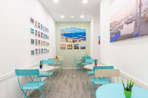 a waiting room with tables and blue chairs at b&b don Mimì in Naples