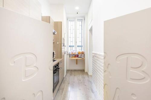 a white kitchen with white walls and white floors at b&b don Mimì in Naples