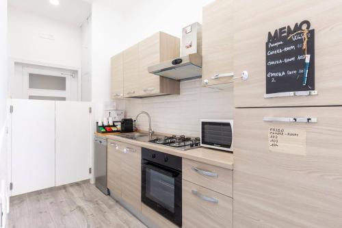 a kitchen with a stove top oven next to a refrigerator at b&b don Mimì in Naples