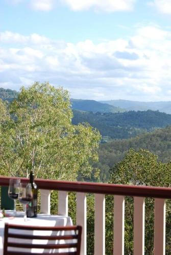 a table and chairs on a balcony with a view at Nunyara Retreat. Quality bush retreat in Wolfdene