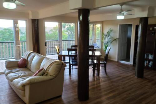 a living room with a couch and a table at Nunyara Retreat. Quality bush retreat in Wolfdene