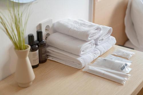 a pile of towels and bottles on a table at Aank Hotel Cheonan Station 1st in Cheonan