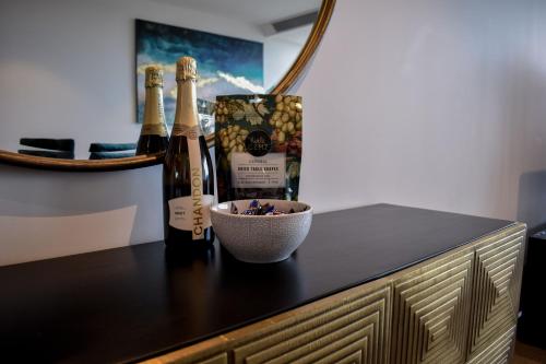 a counter with two bottles of wine and a bowl at Fantastic 3 Bedroom Apartment in Southbank in Melbourne