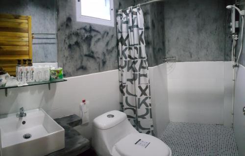 a bathroom with a sink and a toilet and a shower at Greenery Resort Koh Tao in Koh Tao