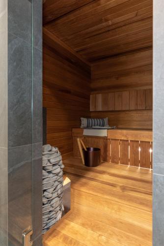 a sauna with wood paneling and a glass wall at Tamula Sauna Apartment 54 in Võru
