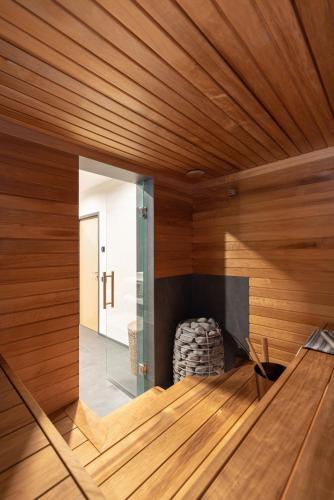 a sauna with wooden walls and a large mirror at Tamula Sauna Apartment 54 in Võru