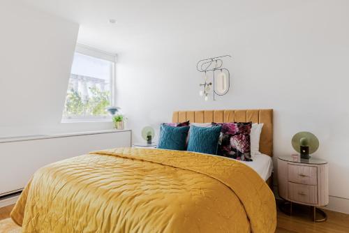 a bedroom with a bed with a yellow blanket at Stunning Covent Garden DREAM COME TRUE Super Quiet HOTEL Alike HOME in London