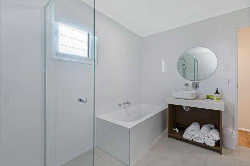 a bathroom with a shower and a sink and a mirror at Reflections Evans Head - Holiday Park in Evans Head