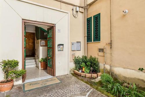 an open door of a building with plants outside at b&b don Mimì in Naples