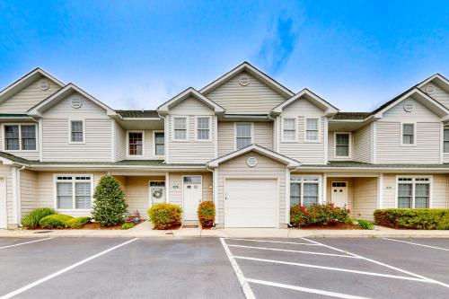a house with a parking lot in front of it at The Tides -- 19973 Sandy Bottom #304 in Rehoboth Beach
