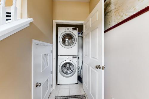 a laundry room with a washer and dryer at The Tides -- 19973 Sandy Bottom #304 in Rehoboth Beach
