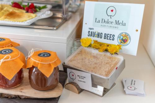 a counter with a box of chocolate and a container of food at Agritur La Dolce Mela - Adults Only in Vezzano