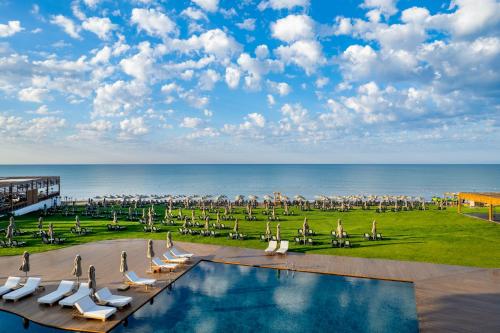 a view of a pool with chairs and the ocean at Rixos Park Belek - The Land Of Legends Access in Belek