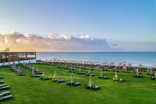a group of tables and chairs on the beach at Rixos Park Belek - The Land Of Legends Access in Belek