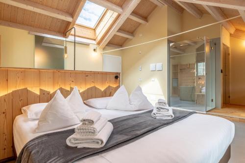 a bedroom with a large bed with towels on it at Agritur La Dolce Mela - Adults Only in Vezzano