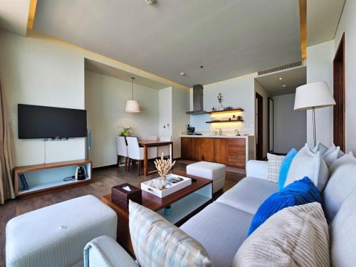 a living room with a couch and a tv at Stunning Apartments Across My Khe Beach ! Rooftop Pool & Gym in Da Nang