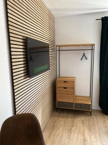 a living room with a tv on a wall at S17 ferienappartments in Flensburg