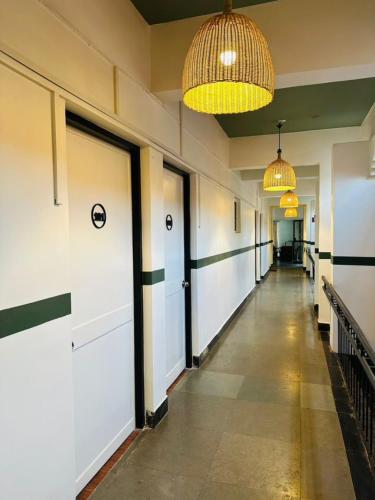 a hallway of a building with doors and lights at Olive Zip Calangute Mira by Embassy Group in Calangute