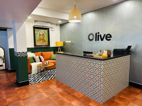 a hotel lobby with a live counter in a room at Olive Calangute Mira - by Embassy Group in Calangute