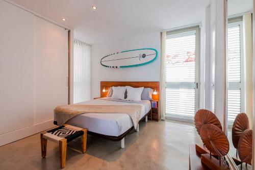 聖約瑟夫沙塔萊亞的住宿－SURF HOUSE，卧室配有一张床铺,墙上设有冲浪板