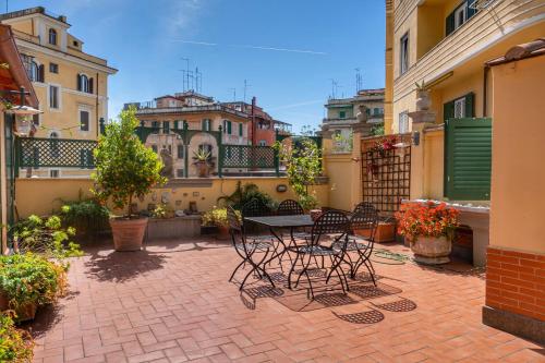 a patio with a table and chairs on a balcony at Terrazza San Saba in Rome