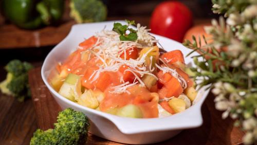 a bowl of food on a table with broccoli at Hotel 88 Bekasi By WH in Bekasi