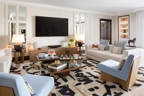a living room filled with furniture and a flat screen tv at Jumeirah Dar Al Masyaf Dubai in Dubai