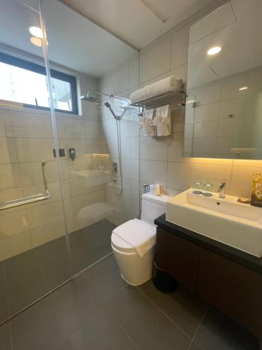 a bathroom with a toilet and a shower and a sink at The ECON at Genting Highlands in Genting Highlands