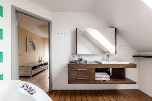 a bathroom with a sink and a mirror at Lovely spacious apartment in the city center in Kuressaare