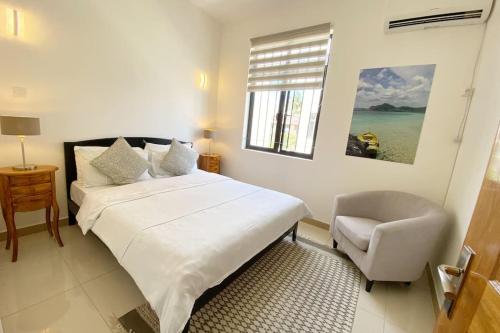 Ένα ή περισσότερα κρεβάτια σε δωμάτιο στο Agréable appart T4 avec Piscine à Pereybère.