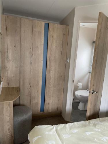 a bedroom with a bed and a bathroom with a toilet at Weymouth bay haven in Preston
