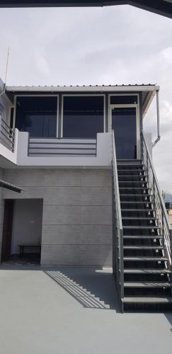 a building with stairs leading to a stair case at Fourseason frankcottage in Chikmagalūr
