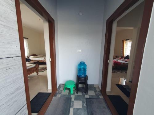 a hallway with a large bottle of water in a room at Fourseason frankcottage in Chikmagalūr