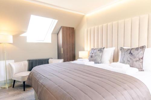 a bedroom with a large bed and a window at Sweeney Aviemore One in Aviemore
