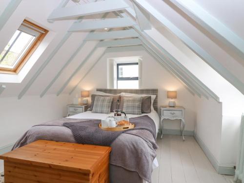 a bedroom with a bed in a attic at Dunira in Cupar