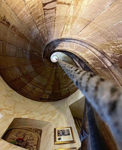 a spiral staircase in a building with a wooden ceiling at Maison Kammerzell - Hotel & Restaurant in Strasbourg