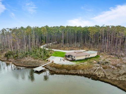 an aerial view of a house in the middle of a lake at Water's Edge Retreat home in Smyrna