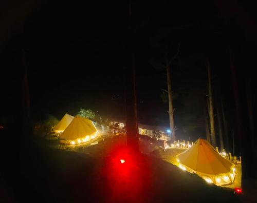 a group of tents with lights at night at Nacasoo hill in Tiên Hai