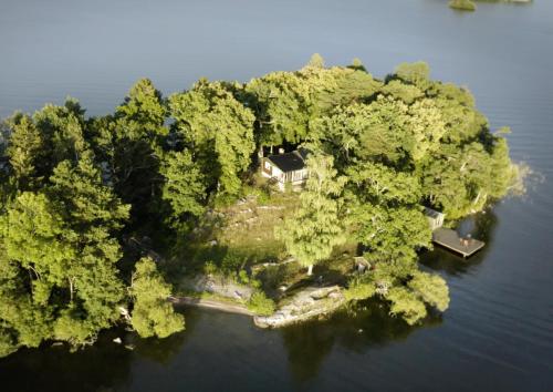 an island in the water with a house on it at Escape to Your Very Own Private Island - Just 30 Minutes from Stockholm in Svartsjö